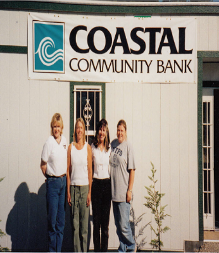 Coastal Community Bank original Darrington staff posing in front of bank building