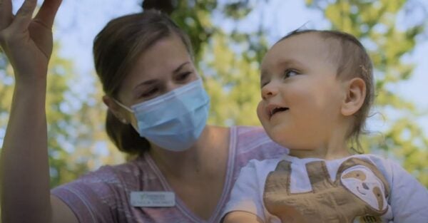 Sherwood Community Services and Coastal Community Bank YouTube video grab of woman playing with baby