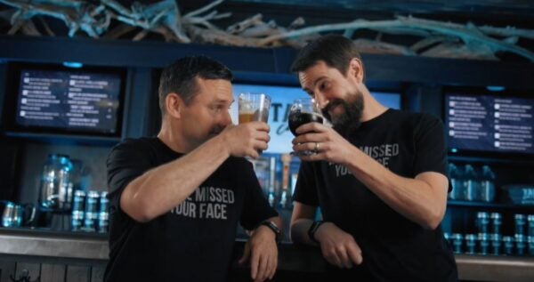 The owners of Tapped Camano cheers each other thanks to the support they received from Coastal