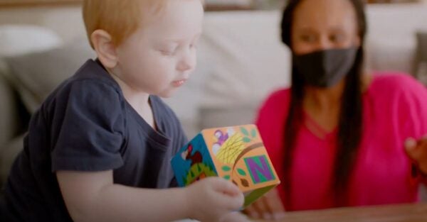 ChildStrive partners with families and the community - woman working with young child